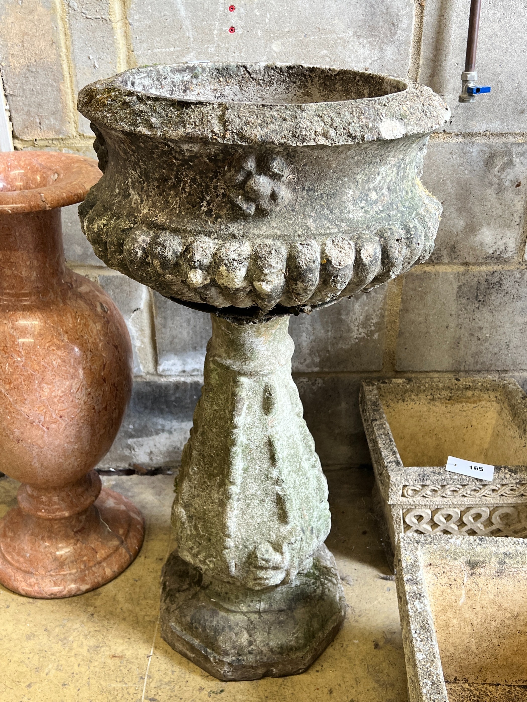 A reconstituted stone circular garden fountain, diameter 43cm, height 84cm